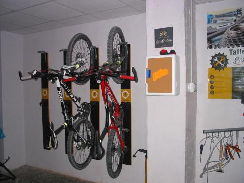 a wall with two bikes hanging on a wall at Hotel Meridional in Guardamar del Segura