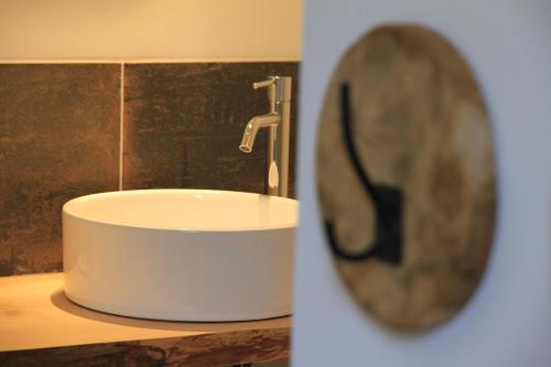 a white sink in a bathroom with a mirror at Gites-Terroirs-Occitanie in Felluns