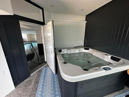 a bathroom with a bath tub in a room at PJ Motel Pilot in Cazin