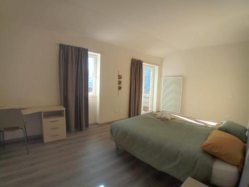 a bedroom with a bed and a desk in it at Terra e Radici_Castanea in Torre di Santa Maria