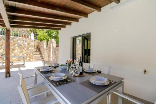 a dining room with a table and chairs at Villa Redonda by Algarve Holidays in Loulé