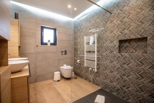 a bathroom with a toilet and a sink and a shower at Villa Redonda by Algarve Holidays in Loulé