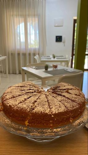 a large chocolate cake on a glass plate on a table at San Michele Apartments&Rooms in Catanzaro