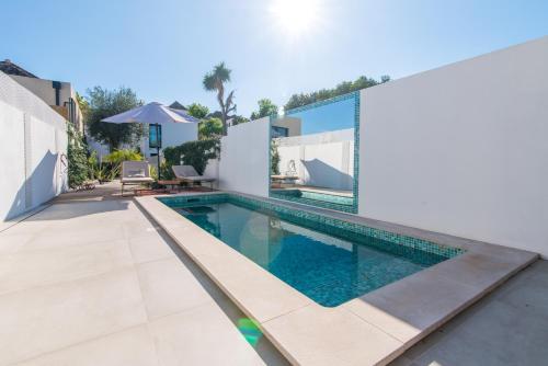 an image of a swimming pool in a house at Rocco House By ALGARTUR in Tavira