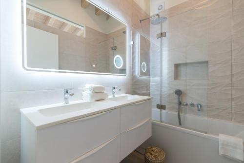 a white bathroom with a sink and a shower at Rocco House By ALGARTUR in Tavira