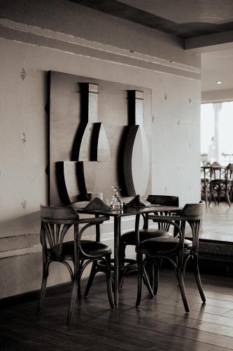 a dining room with a table and chairs and vases at Gravity Hotel & Aqua Park Hurghada Families and Couples Only in Hurghada