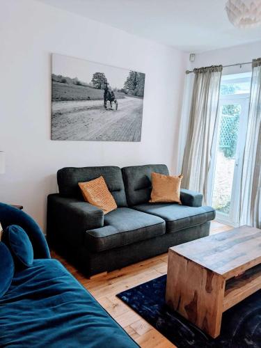 a living room with a couch and a coffee table at Cardiff 2 Bedroom Luxury House in Cardiff