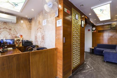an office with a reception desk and a waiting room at Collection O Hotel Kyra in Ahmedabad