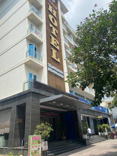 a hotel with a sign on the front of it at Central Hotel in Móng Cái