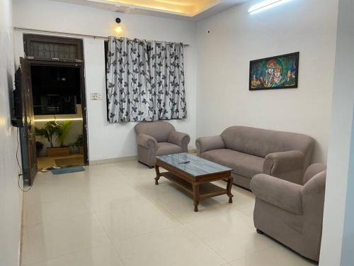 a living room with two couches and a coffee table at Leela home stay - Lotus (2 BHK luxury appartment) in Jabalpur