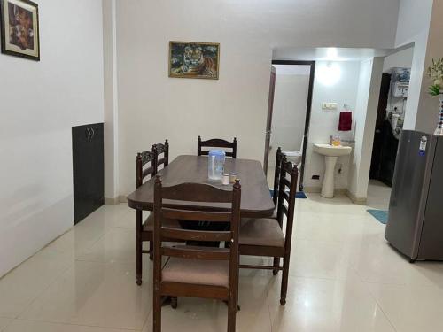 a dining room with a table and chairs and a refrigerator at Leela home stay - Lotus (2 BHK luxury appartment) in Jabalpur