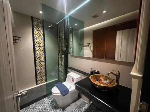 a bathroom with a toilet and a sink and a shower at Le Maroc Hotel Patong in Patong Beach
