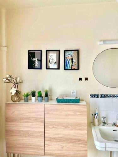 La salle de bains est pourvue d'un lavabo et d'une coiffeuse avec un miroir. dans l'établissement 2-Bed Room Cosy Apartment - Central Location, à Paris