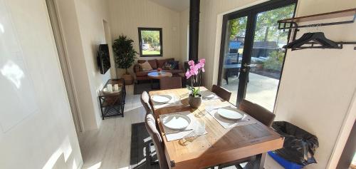 a dining room with a wooden table with flowers on it at Långasjönäs Camping & Stugby in Karlshamn