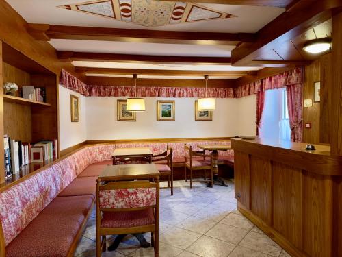 a restaurant with tables and chairs in a room at PANORAMA SportHOTEL in Folgaria