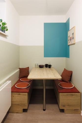 a table and two benches in a room at POHA House Büchel in Aachen