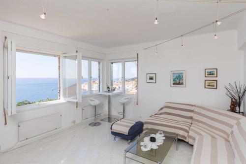 a bedroom with a bed and a view of the ocean at Apartment Rea in Dubrovnik