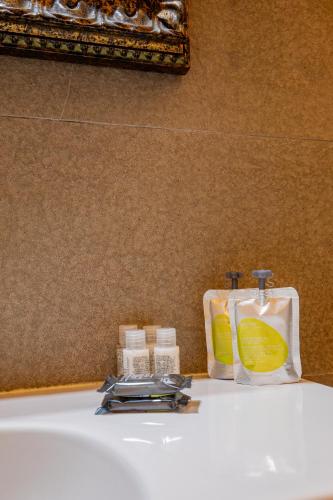 a white sink with two bottles and a bag on it at Alla Marina Affittacamere in Riomaggiore