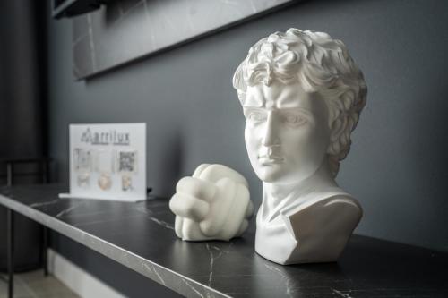 a statue of a bust sitting on a table at Marrilux apartments Residence Hill in Kopaonik