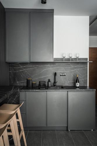 a kitchen with stainless steel cabinets and a sink at Marrilux apartments Residence Hill in Kopaonik
