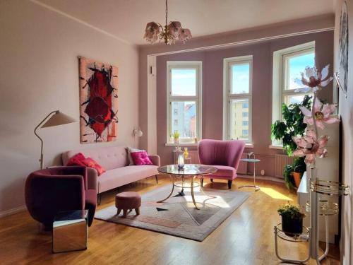 a living room with a couch and a table at Lovely Vintage Suite in Helsinki