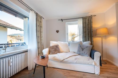 a living room with a white couch and a window at Bergjuwel in Garmisch-Partenkirchen
