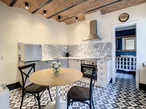 a kitchen with a table and chairs in a room at Villa Victoria in Caminha