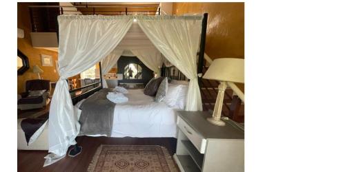 a bedroom with a bed with a canopy at Winston House in Durban
