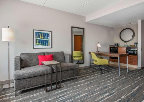 a living room with a couch and a desk at Hampton Inn & Suites Dallas-Allen in Allen