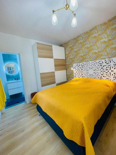 a bedroom with a large yellow bed in a room at La Dolce Vita Penthouse 2 Bedroom Apartment in Arona