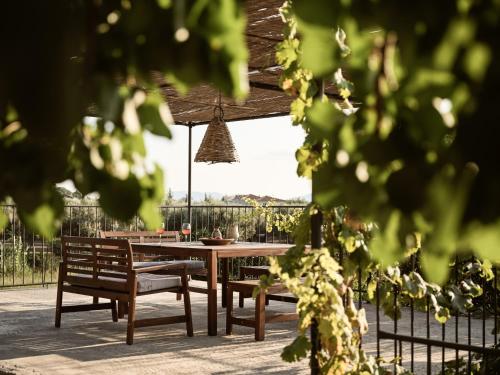 a wooden table and two benches and a table and chairs at PHI Simple Living Quarters in Akrotiri