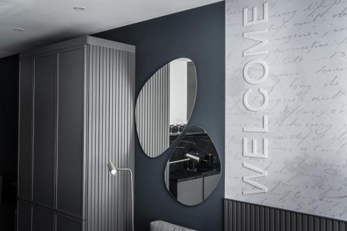 a bathroom with a mirror on a wall with writing at Marrilux apartments Residence Hill in Kopaonik