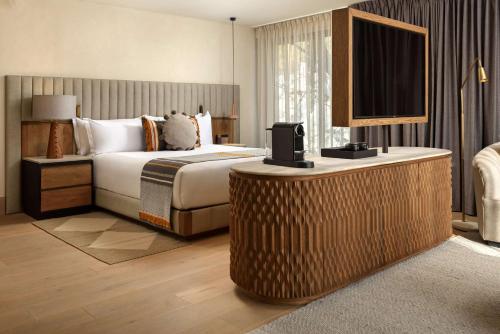 a hotel room with a bed and a flat screen tv at NUMU Boutique Hotel, The Unbound Collection by Hyatt in San Miguel de Allende