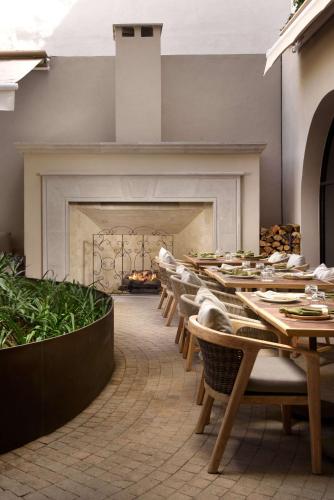 a dining room with tables and chairs and a fireplace at NUMU Boutique Hotel, The Unbound Collection by Hyatt in San Miguel de Allende
