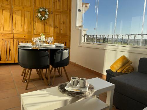 a living room with a table and a dining room at Casa Estefania in Sucina