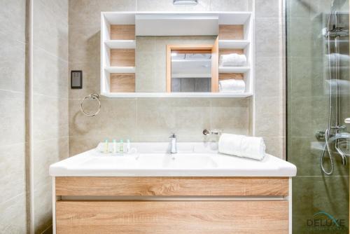 a bathroom with a sink and a shower at Romantic Studio in Pantheon Elysee JVC by Deluxe Holiday Homes in Dubai