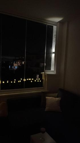 a dark room with a window with a view of a city at Casa Estefania in Sucina
