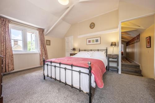 a bedroom with a bed and a window at The Old Coach House C in Grimston