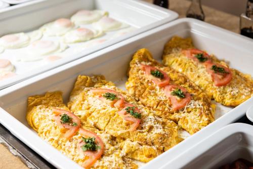 two styrofoam containers filled with eggs with tomatoes at Olympic Star Beach Hotel in Nei Poroi