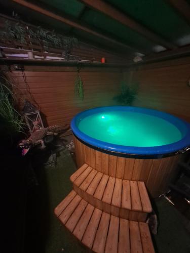 a large wooden tub with a green water in it at Yacht Club in Liepāja