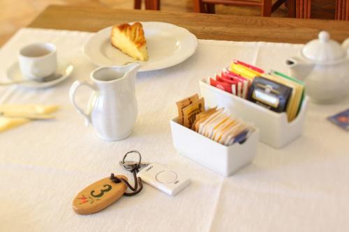 a table with a plate of cake and a cup of coffee at Agriturismo Tonutti in Tavagnacco