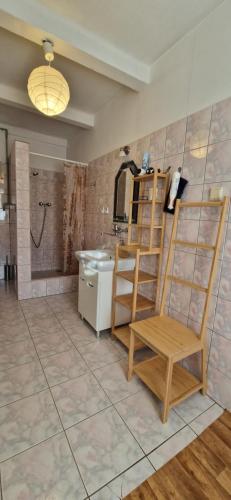 een badkamer met een wastafel en een houten stoel bij Apartament Orkisz in Zakopane