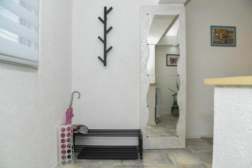 a hallway with a bench and a wall with a clock at L & S BANJICA in Belgrade