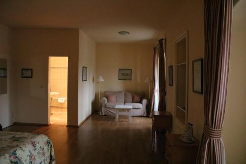 a living room with a couch and a table at Hotel Schloss & Gut Ulrichshusen in Ulrichshusen