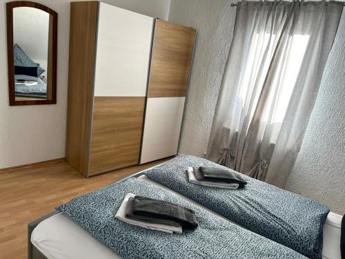 a bedroom with two beds and a dresser and a mirror at Wohnung VS 3 in Villingen-Schwenningen