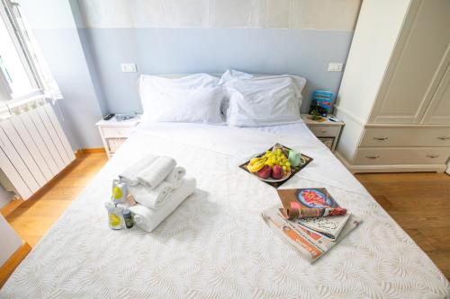a white bed with a tray of food on it at Alla Marina Affittacamere in Riomaggiore
