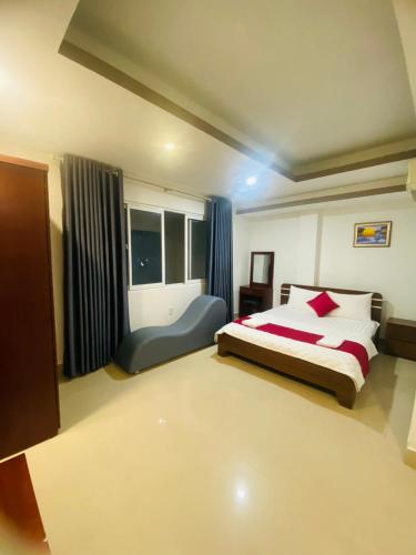 a large bedroom with a bed and a window at Phú Gia 464 NVL in Ho Chi Minh City