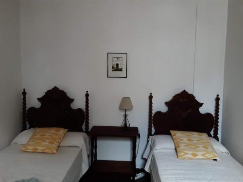 a room with two beds and a table with a lamp at YourHouse Cas Forner in Maria de la Salut