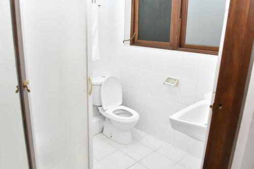 a bathroom with a toilet and a sink at Urban Deck in Colombo