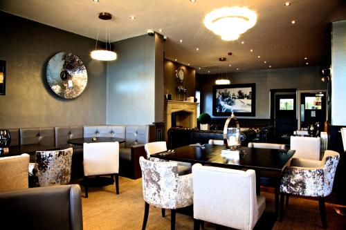 a restaurant with a dining room with tables and chairs at The Eccleston Hotel; BW Signature Collection in Saint Helens